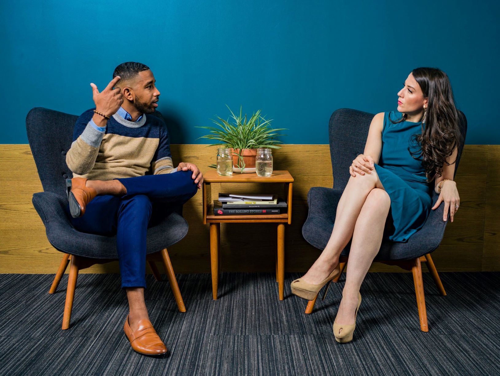 Courageous conversations at work are depicted with two coworkers having a conversation.. 