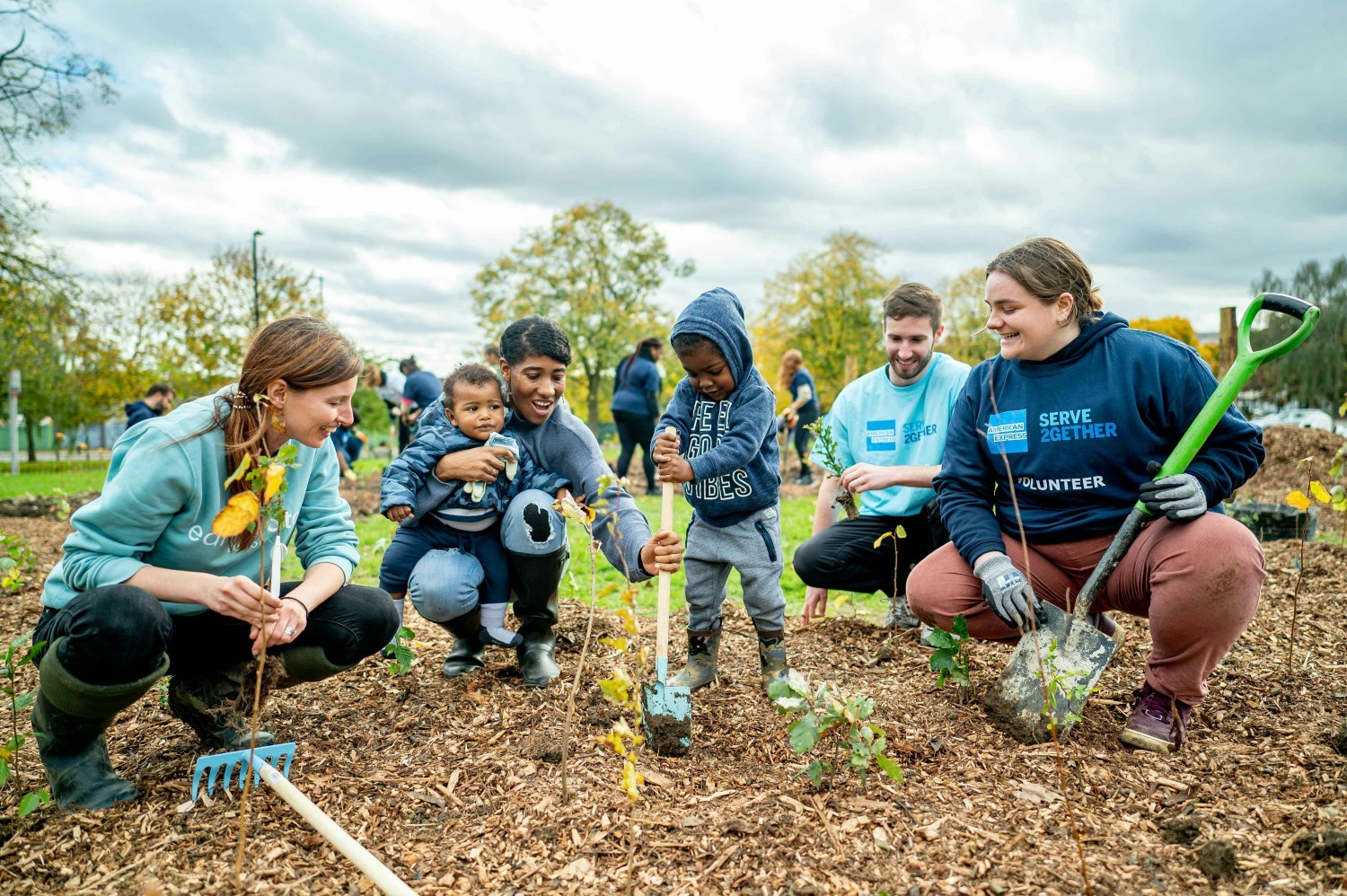 Volunteerism is depicted with American Express employees volunteer together