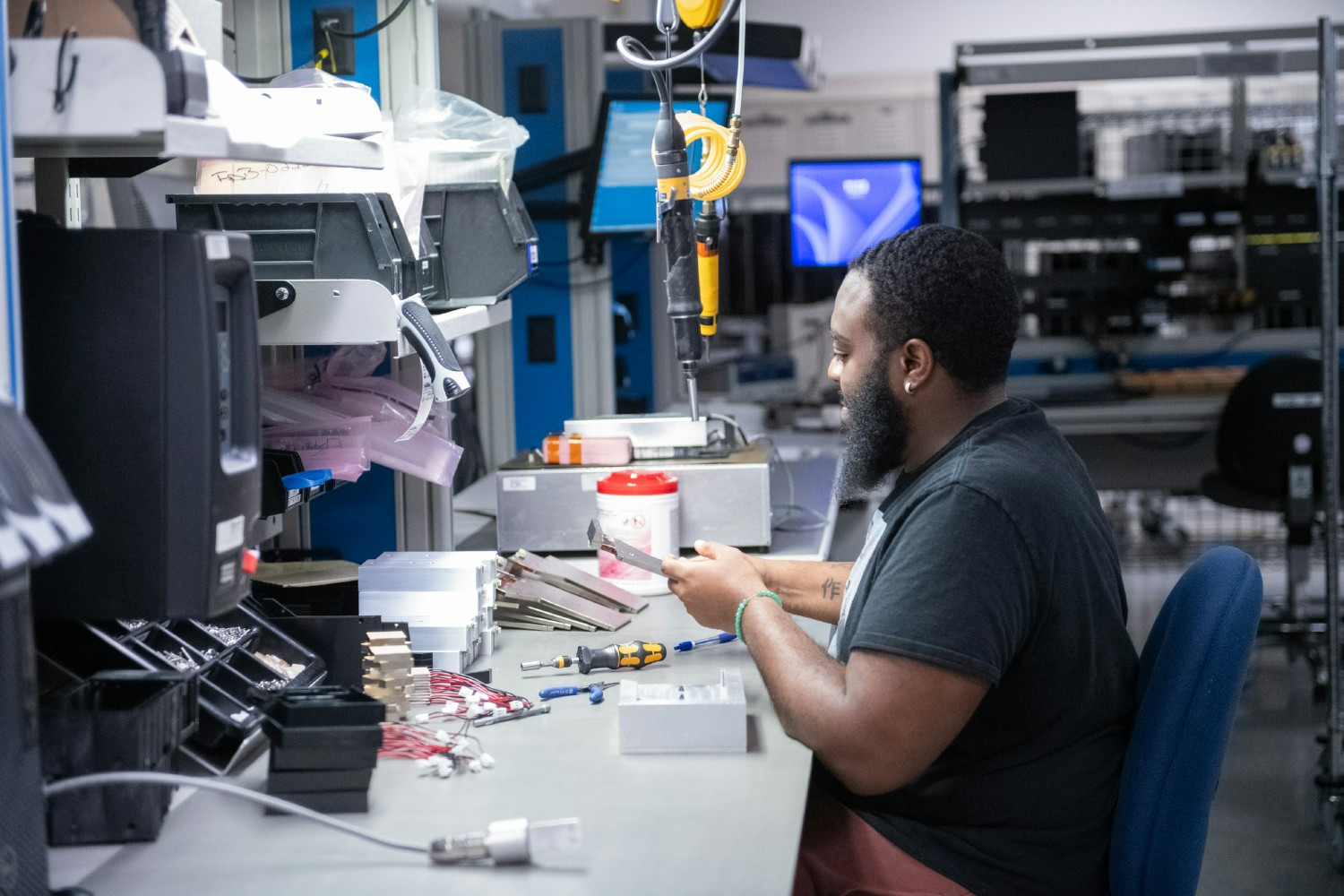 A team member works on a component for Hologic's 3D mammography system. Hologic invented 3D mammography.